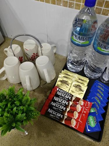 a counter with a bottle of water and some snacks at Malacca City Center Town House by 360HOME in Melaka