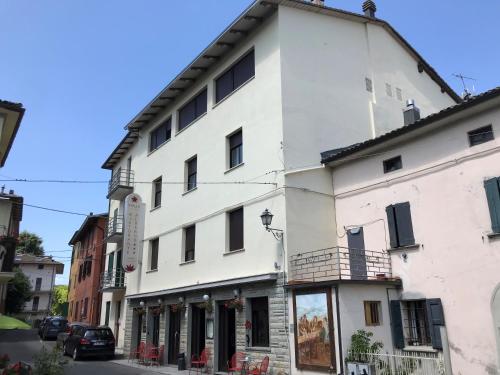 a white building on the side of a street at Albergo Stella in Tolè