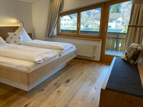 a bedroom with two beds and a large window at Zani Helga in Schruns