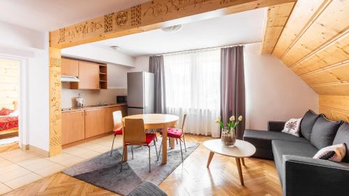 a living room with a couch and a table at Apartament Krzeptowskiego 33 in Zakopane