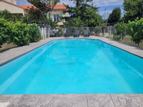 une piscine avec de l'eau bleue dans une maison dans l'établissement 2 bedroom ground floor modern apartment 4km beach, à Villelongue-de-la-Salanque