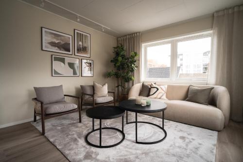 a living room with a couch and chairs and a table at Enter Viking Apartment Hotel in Tromsø