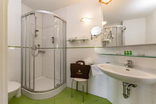 a bathroom with a glass shower and a sink at Ferienwohnungen Kesselgrub in Altenmarkt-Zauchensee in Altenmarkt im Pongau