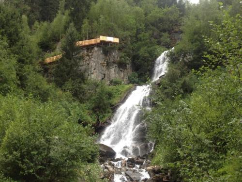 a waterfall in the middle of a forest at Apartment in Pitztal near Ski Glacier in Oberlehn