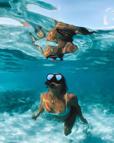 a group of people swimming in the water at Pousada Serra&Mar Angra dos reis in Angra dos Reis