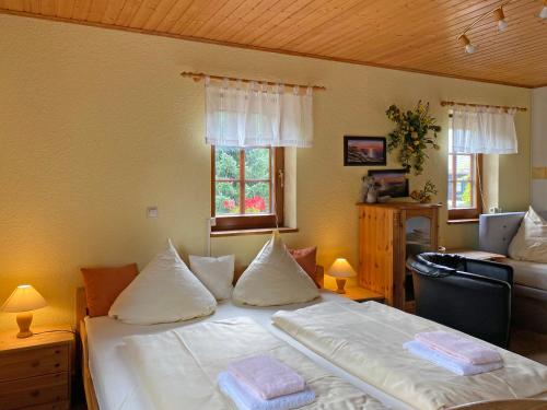 a bedroom with a bed with two pillows on it at RATAGS Kunsthandwerkerhaus in Langenwolmsdorf