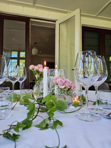 a table with wine glasses and flowers and candles at Arbottna Herrgård AB in Muskö