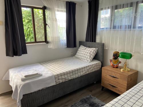 a small bedroom with a bed and a window at Artur holiday city - double room in Gomec