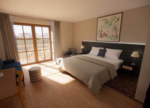 キッツビュールにあるHENRI Country House Kitzbühelのベッドルーム(白いベッド1台、大きな窓付)