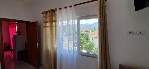 a room with a large window and a curtain at Bar-Restaurant-Hotel-Familja in Klos