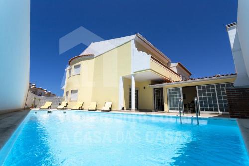 a villa with a swimming pool and a house at Villa BelaVista by ACasaDasCasas in Ericeira