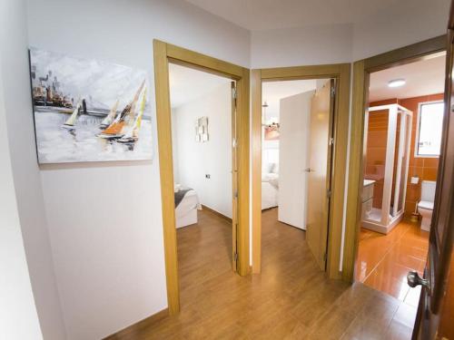 a room with a hallway with a painting on the wall at Jardines del Mar Salobreña in Salobreña