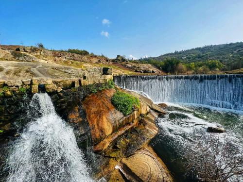 an aerial view of a waterfall on a mountain at Quinta Alma Verde in Póvoa das Quartas