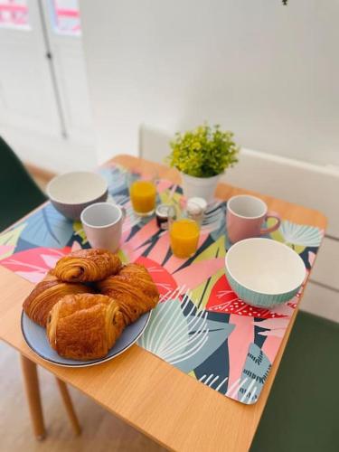 a table with a plate of croissants on it at L’échappée verte in Caussade
