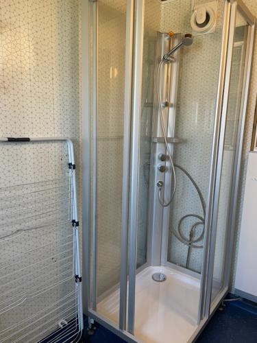 a shower with a glass door in a bathroom at Centralt belägen villa i Öjebyn, Piteå in Piteå
