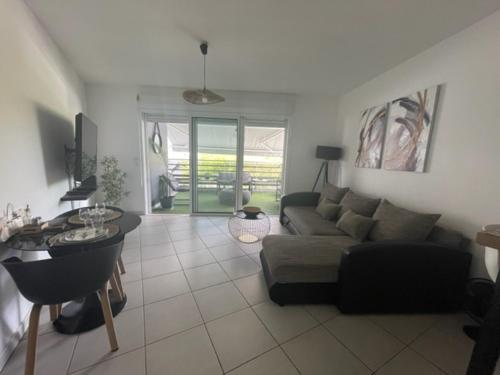 a living room with a couch and a table at Appart Marina étang Z'abricots in Fort-de-France