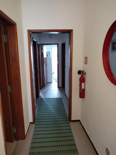 a hallway with a green rug on the floor at Casa da laranjeira in Montargil