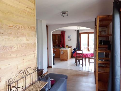 a living room with a couch and a dining room at Appartement des cimes du Granier in Les Déserts