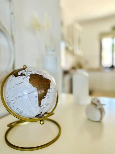 a small globe sitting on a table with a cord at Cozy Cliff Tower w/ Breathtaking Sea Views in Áyios Yeóryios