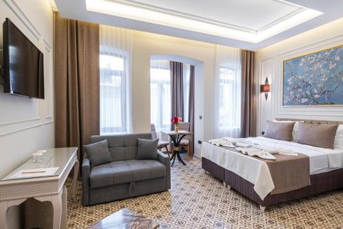 a hotel room with a bed and a chair at Pera Luna Premium Hotel in Istanbul