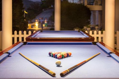 a pool table with three balls and three cuesticks at Labranda Ephesus Princess - All Inclusive in Kusadası