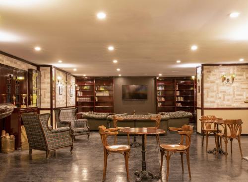a library with chairs and tables and a couch at Labranda Ephesus Princess - All Inclusive in Kusadası