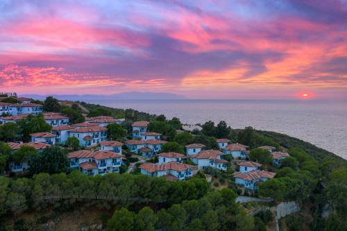 a group of houses on a hill with a sunset at Labranda Ephesus Princess - All Inclusive in Kusadası