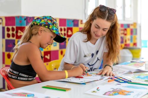 a woman and a little girl doing arts and crafts at Labranda Ephesus Princess - All Inclusive in Kusadası