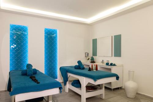 a bathroom with two blue chairs and a sink at Labranda Ephesus Princess - All Inclusive in Kusadası