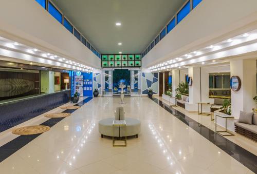 a lobby of a shopping mall with a table in the middle at Labranda Ephesus Princess - All Inclusive in Kusadası