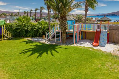 a playground in a yard with a slide at Design Plus Seya Beach Hotel in Alacati