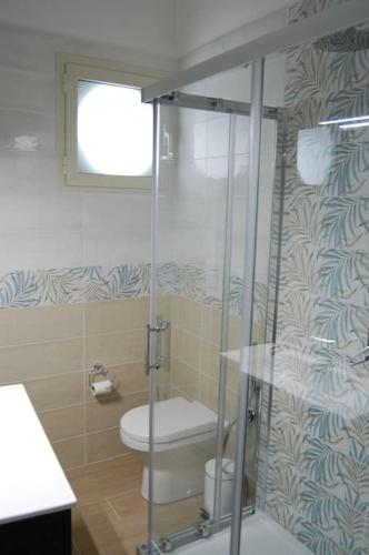a bathroom with a toilet and a glass shower at Casa Vacanze Ida in Cetara