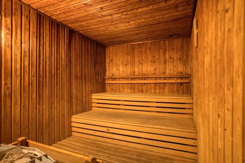 a wooden sauna with wooden steps in it at Asteria Collection Side in Side