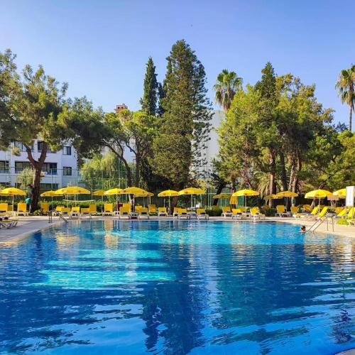 a large swimming pool with umbrellas and chairs at Asteria Collection Side in Side