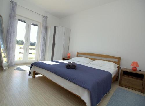 Postel nebo postele na pokoji v ubytování Apartmani Loli