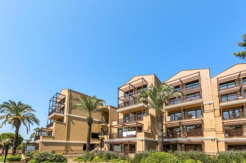 an apartment building with palm trees in the foreground at Asteria Family Resort Belek in Belek