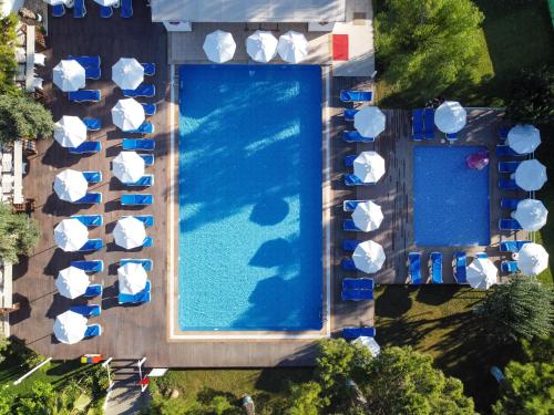 an overhead view of a large swimming pool with umbrellas at Labranda Lebedos Princess - All Inclusive in Seferihisar
