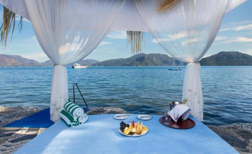 a table with a plate of food on the water at Labranda Mares Marmaris Hotel in Marmaris