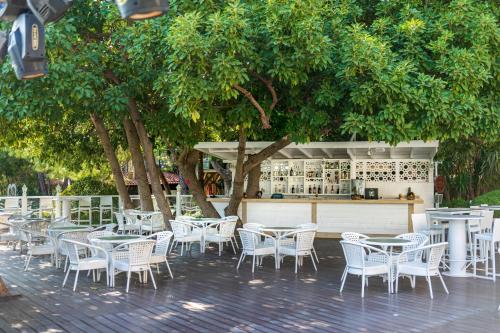 a group of tables and chairs in front of a bar at Labranda Mares Marmaris Hotel in Marmaris