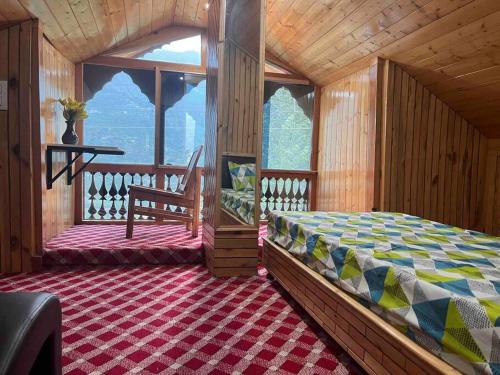 a bedroom with a bed and a large window at Be my guest at Hills in Kulu