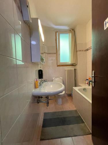 a bathroom with a sink and a toilet and a tub at Bliss - Casale della Vite in Magliaso