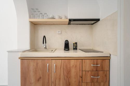 a kitchen with a sink and a counter top at Celestial Seaview Apartments-Dionysios in Naxos Chora