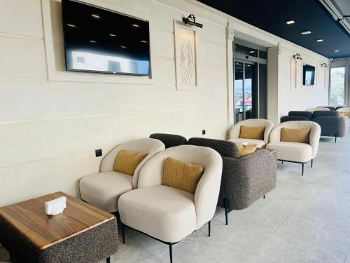 a waiting room with a row of chairs and a table at Monalisa Hotels KUŞADASI in Kusadası