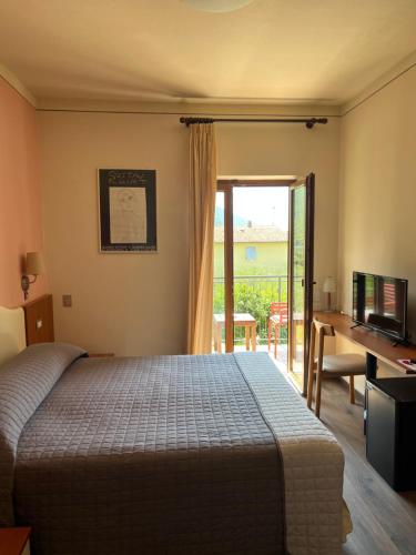 a bedroom with a bed and a desk with a computer at Casa Antonelli in Malcesine