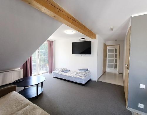 a living room with a couch and a table at Firstroom Gdańsk in Gdańsk