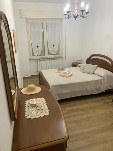 una camera con due letti e un tavolo con un cappello sopra di Valdonica - Relax in campagna a La Spezia