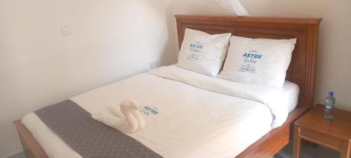 Ένα ή περισσότερα κρεβάτια σε δωμάτιο στο Aster Suites Kisumu