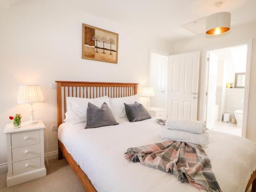 a bedroom with a white bed with two pillows at Baldwin Close in Hook