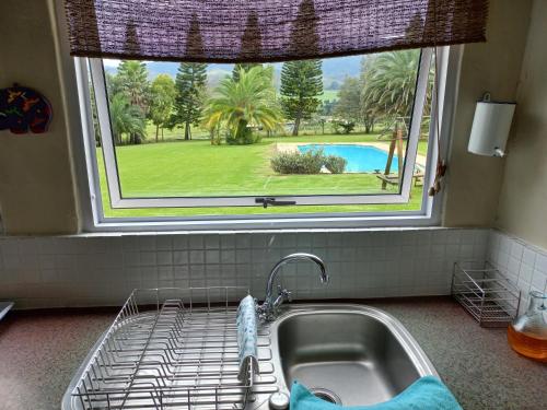 a sink in a kitchen with a large window at Esperanza Countryside Accomodation in George
