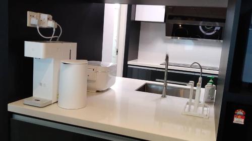 a kitchen with a counter with a mixer and a sink at Lumi Tropicana, Petaling Jaya 01 Golf View in Petaling Jaya